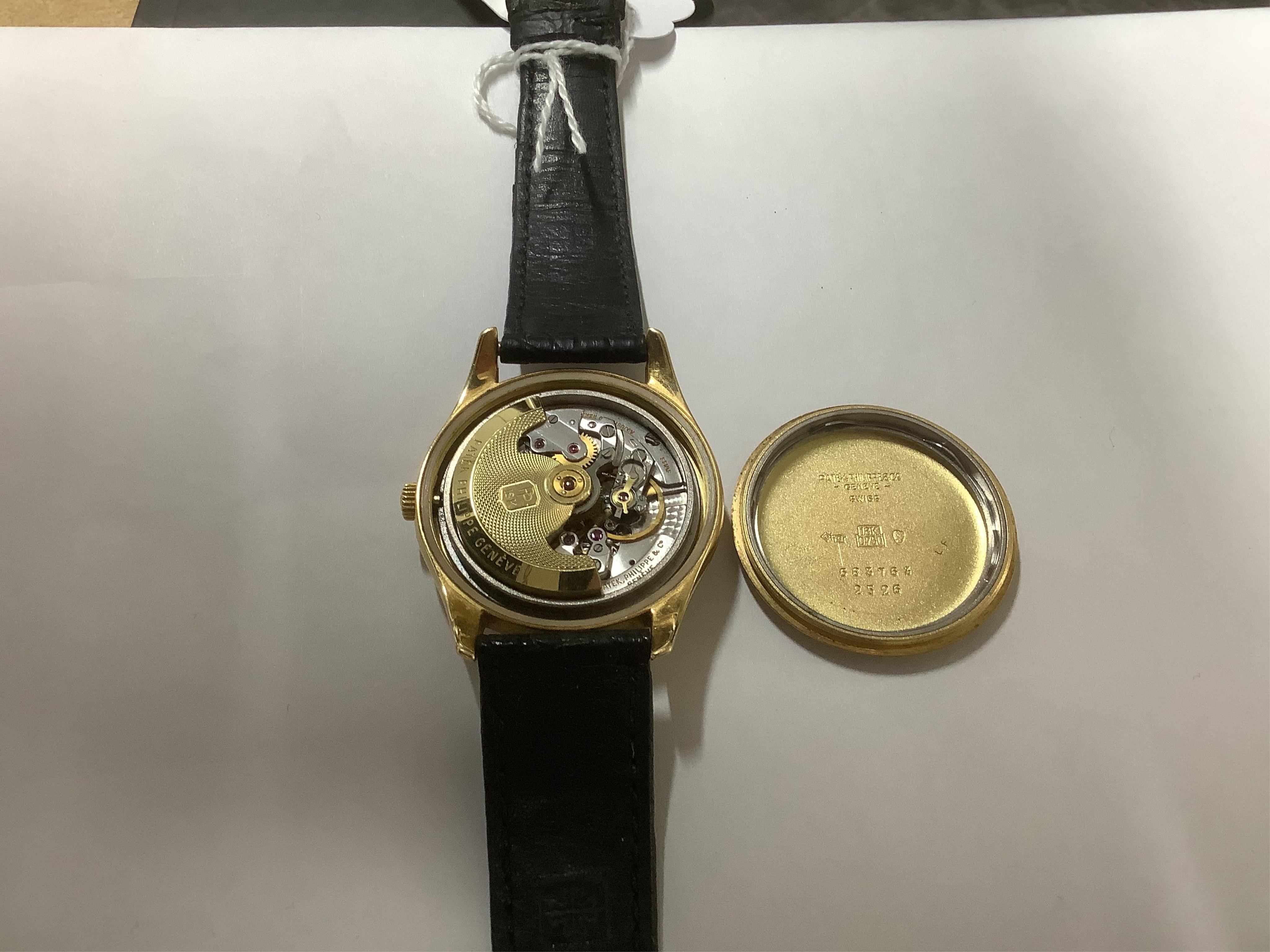 A gentleman's fine 18ct gold Patek Philippe Calatrava automatic wrist watch, model number 2526, on a Patek Philippe black leather strap with a Patek Philippe 18ct gold buckle